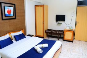 Delux king bed with TV at Hotel Alka Residency.