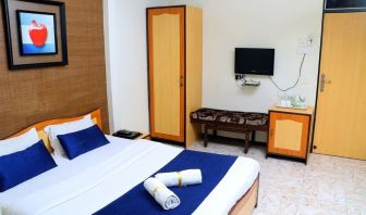 Delux king bed with TV at Hotel Alka Residency.