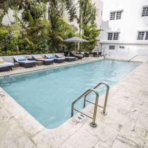 Relaxing pool area with sun loungers at Hotel Croydon.