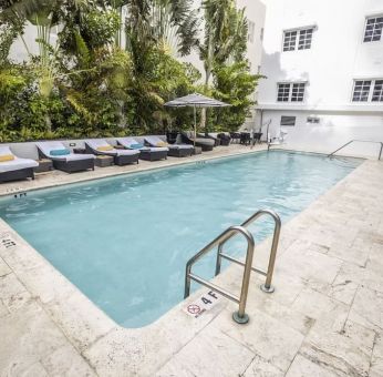 Relaxing pool area with sun loungers at Hotel Croydon.