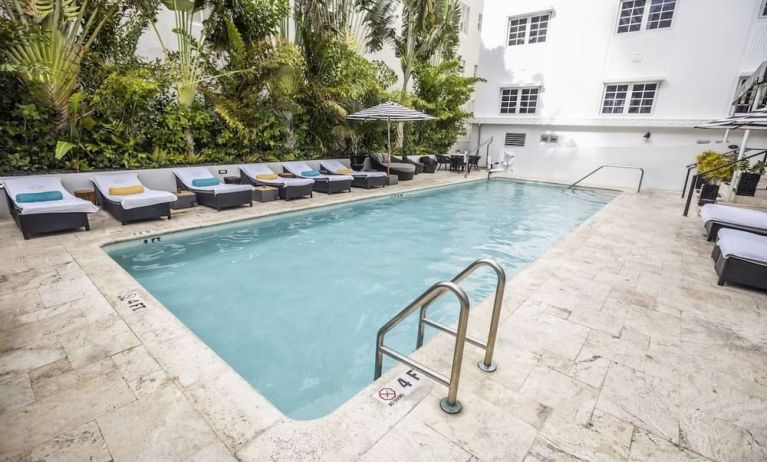 Relaxing pool area with sun loungers at Hotel Croydon.