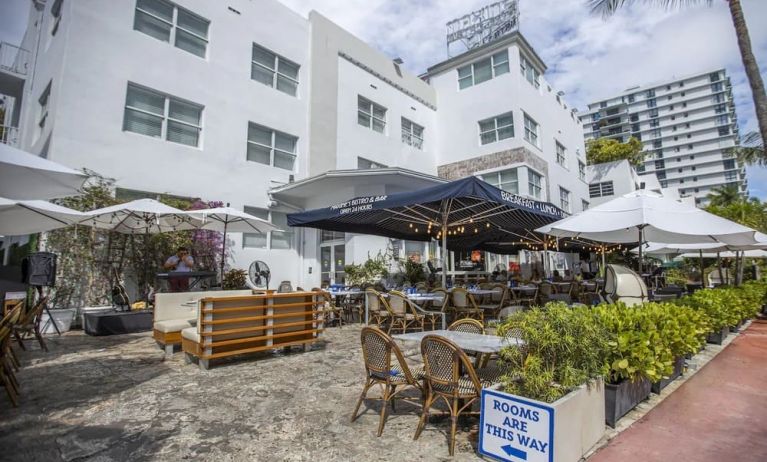 Comfortable outdoor tables and chairs with umbrellas ideal for coworking at Catalina Hotel & Beach Club.