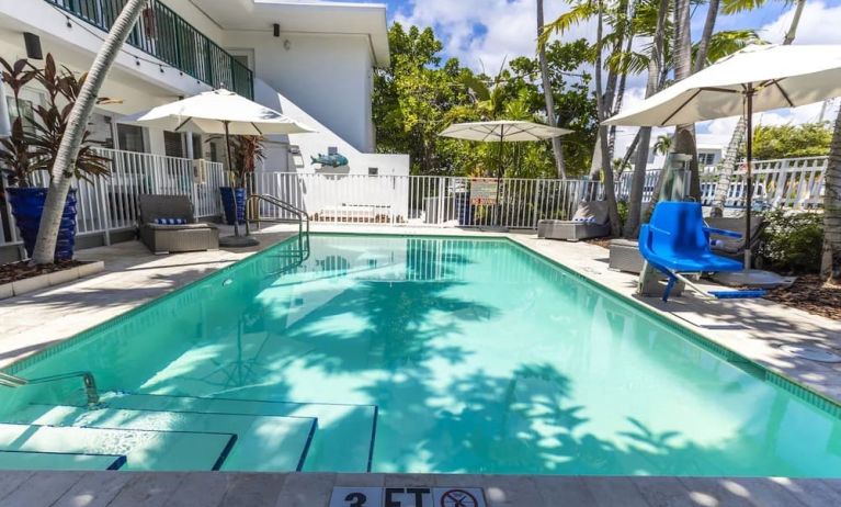 Relaxing pool with surrounding seating area at Seaside All Suites Hotel.