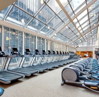 Large fitness center with treadmills at the New York Hilton Midtown.