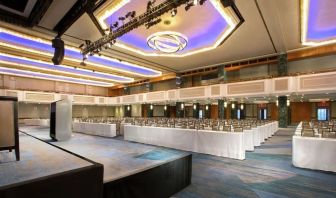 Meeting room with comfortable chairs and TV screen at the New York Hilton Midtown.