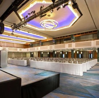 Meeting room with comfortable chairs and TV screen at the New York Hilton Midtown.