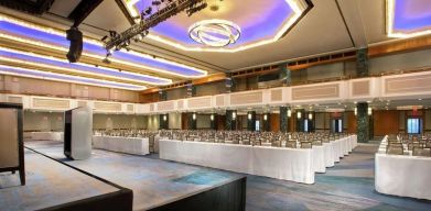 Meeting room with comfortable chairs and TV screen at the New York Hilton Midtown.