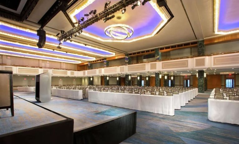 Meeting room with comfortable chairs and TV screen at the New York Hilton Midtown.