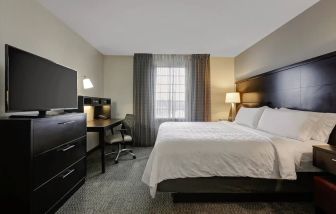 King bed with TV at Staybridge Suites Washington D.C.- Greenbelt.