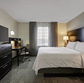 King bed with TV at Staybridge Suites Washington D.C.- Greenbelt.