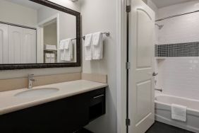 Private guest bathroom with shower and bath combo at Staybridge Suites Washington D.C.- Greenbelt.