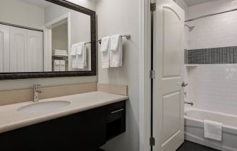 Private guest bathroom with shower and bath combo at Staybridge Suites Washington D.C.- Greenbelt.