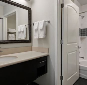 Private guest bathroom with shower and bath combo at Staybridge Suites Washington D.C.- Greenbelt.