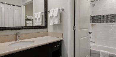 Private guest bathroom with shower and bath combo at Staybridge Suites Washington D.C.- Greenbelt.