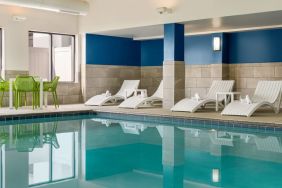 The hotel’s large indoor swimming pool, with surrounding chairs and loungers.