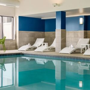 The hotel’s large indoor swimming pool, with surrounding chairs and loungers.