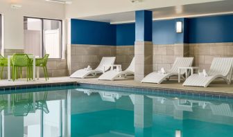 The hotel’s large indoor swimming pool, with surrounding chairs and loungers.