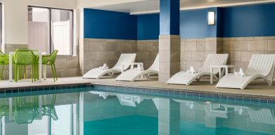 The hotel’s large indoor swimming pool, with surrounding chairs and loungers.