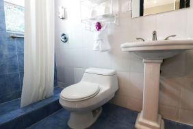 Guest bathroom with shower at Hollywood Beach Suites, A South Beach Group Hotel.