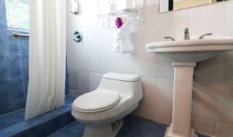 Guest bathroom with shower at Hollywood Beach Suites, A South Beach Group Hotel.