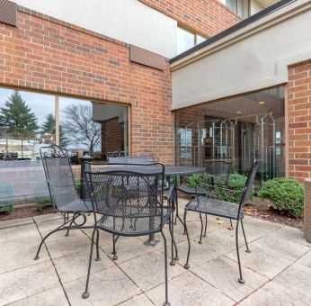 Outdoor terrace with seating at Holiday Inn Express Chicago - Downers Grove.