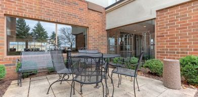 Outdoor terrace with seating at Holiday Inn Express Chicago - Downers Grove.