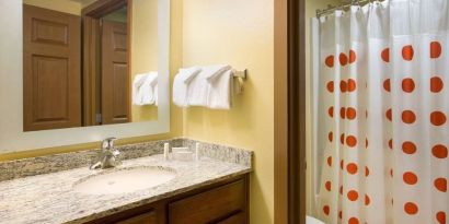 Private guest bathroom with shower at Sonesta Simply Suites Phoenix Scottsdale.