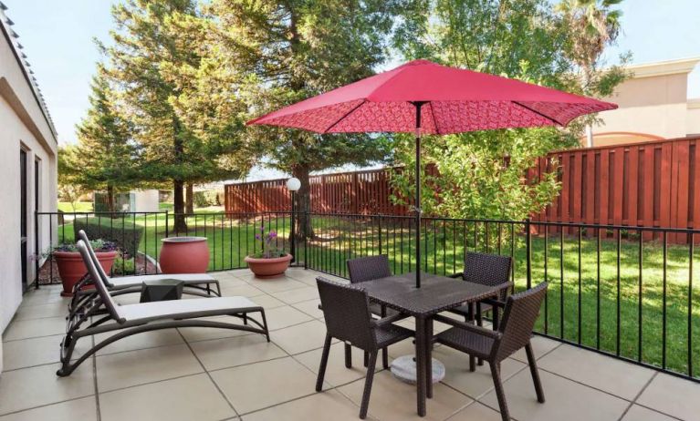 Outdoor garden and terrace at Hampton Inn Tracy.