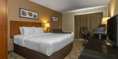 Comfort Inn Sydney double bed guest room with sofa and TV.