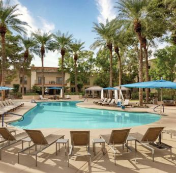 Stunning outdoor pool with sun beds at Hilton Scottsdale Resort & Villas.