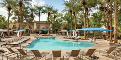 Stunning outdoor pool with sun beds at Hilton Scottsdale Resort & Villas.