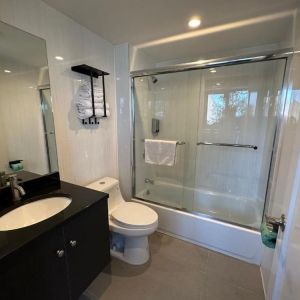 Guest bathroom with shower at Regal Inn & Suites New York.