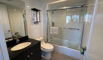 Guest bathroom with shower at Regal Inn & Suites New York.