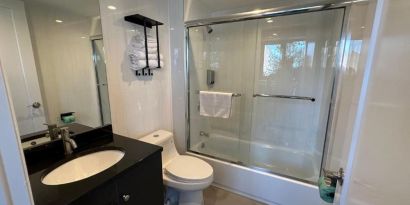 Guest bathroom with shower at Regal Inn & Suites New York.