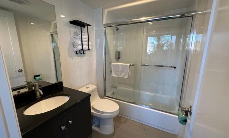 Guest bathroom with shower at Regal Inn & Suites New York.