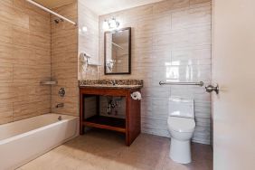 Guest bathroom with shower at Astoria Inn LaGuardia Hotel.