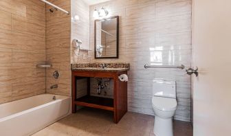 Guest bathroom with shower at Astoria Inn LaGuardia Hotel.