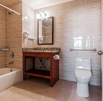 Guest bathroom with shower at Astoria Inn LaGuardia Hotel.