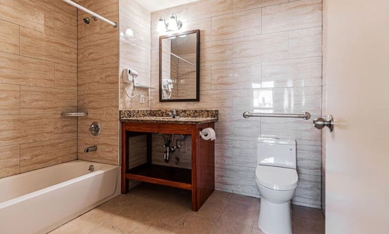 Guest bathroom with shower at Astoria Inn LaGuardia Hotel.