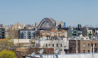 Rooftop terrace with city view at Astoria Inn LaGuardia Hotel.