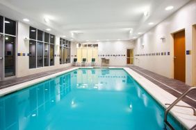 Relaxing indoor pool with seating area at Holiday Inn Aurora North- Naperville.