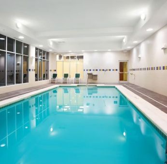 Relaxing indoor pool with seating area at Holiday Inn Aurora North- Naperville.