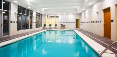 Relaxing indoor pool with seating area at Holiday Inn Aurora North- Naperville.