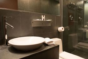 Guest bathroom with shower at Hotel Chelsea, A South Beach Group Hotel.