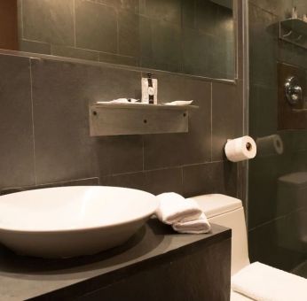 Guest bathroom with shower at Hotel Chelsea, A South Beach Group Hotel.