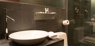 Guest bathroom with shower at Hotel Chelsea, A South Beach Group Hotel.