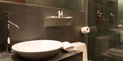 Guest bathroom with shower at Hotel Chelsea, A South Beach Group Hotel.