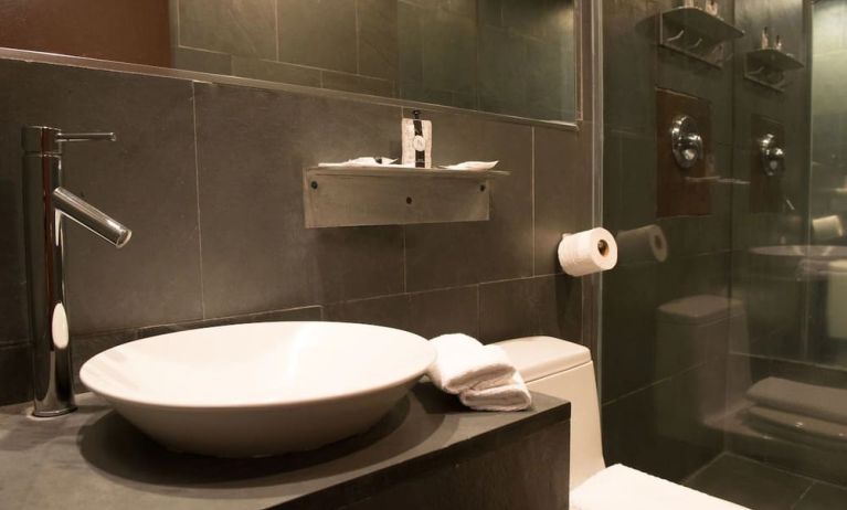 Guest bathroom with shower at Hotel Chelsea, A South Beach Group Hotel.