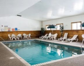 Indoor pool with pool chairs at Norwood Inn & Suites - Roseville.