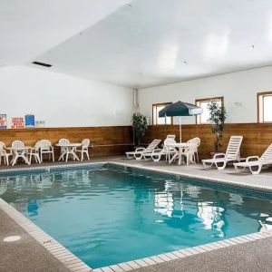 Indoor pool with pool chairs at Norwood Inn & Suites - Roseville.